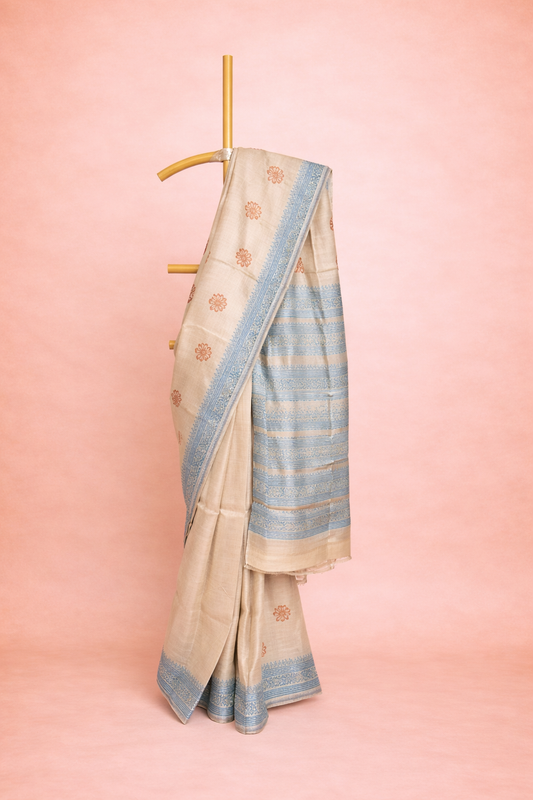 Beige colored block printed hand spun tussar saree with Sky Blue Border