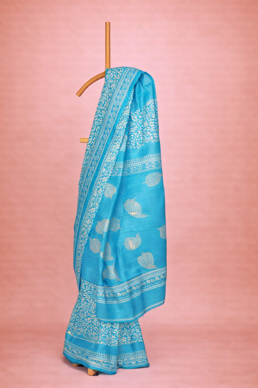 Turquoise blue colored block printed hand spun tussar saree with white floral patterns